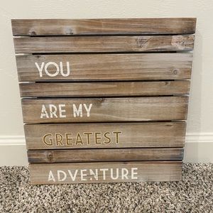 Wood slat "greatest adventure" sign